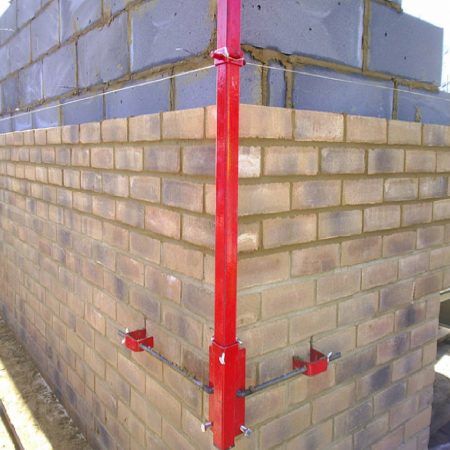 Red steel Mustang 6' External Profile fixed onto the outside corner of a wall in the process of being built