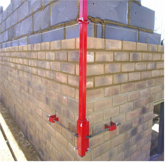 Red steel 6' Mustang external building profile attached to a building in the process of being built