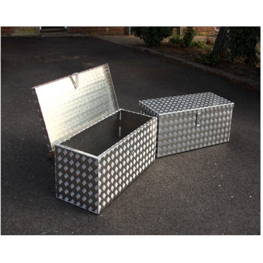 2 aluminum checker plate Mustang storage boxes on concrete, one with its lid open and one with its lid closed