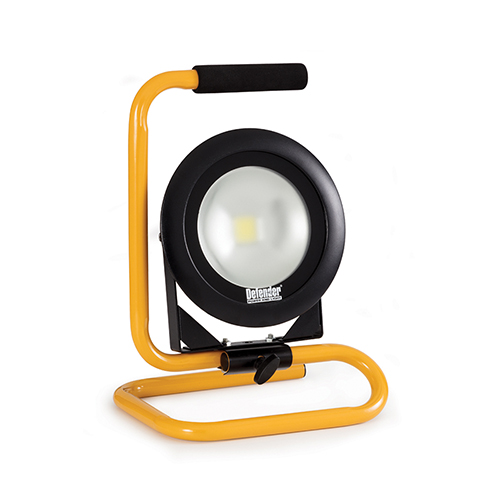 Round Defender DF1200 floorlight with black steel frame mounted onto yellow metal stand