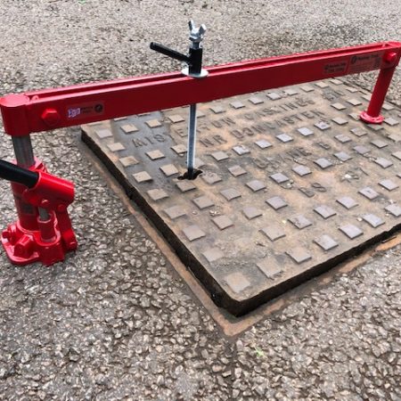 Hydraulic Manhole Cover Seal Breaker Shown set up ready to break the sealed cover lid